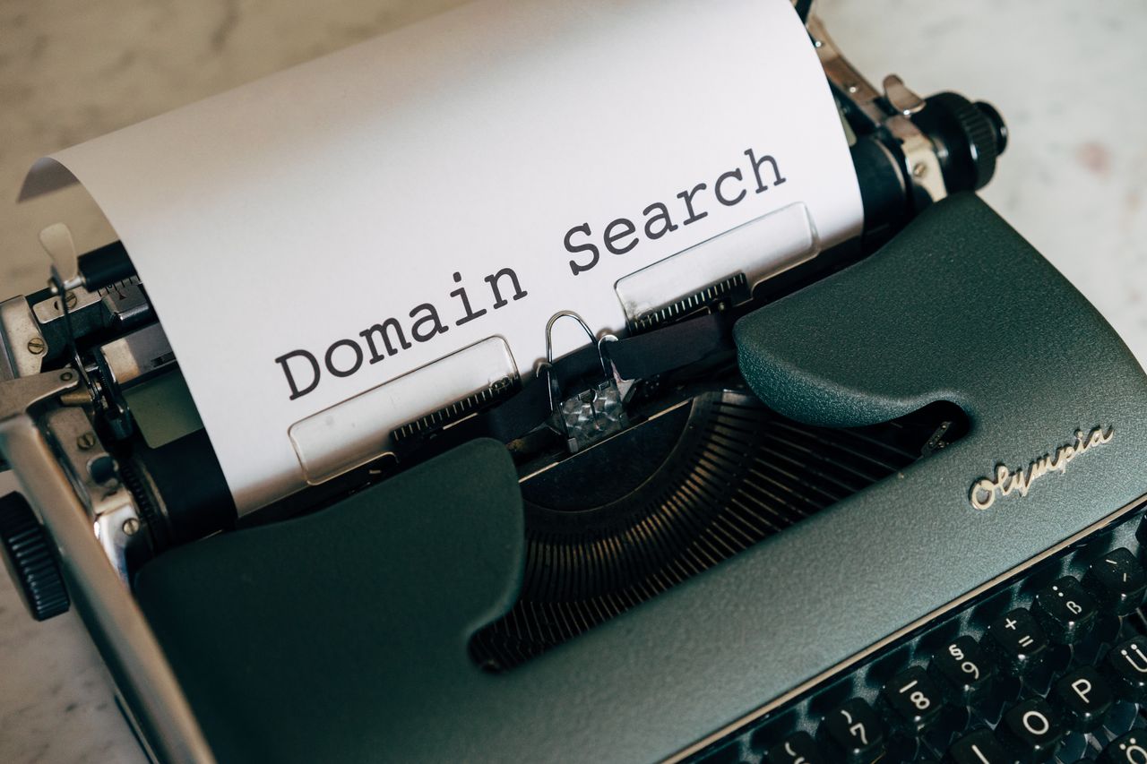 Close-up of a vintage typewriter with paper displaying 'Domain Search' text for conceptual design.